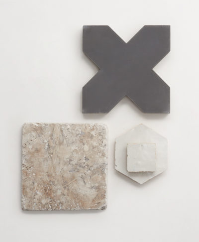 a set of grey and white tiles with an x in the middle.