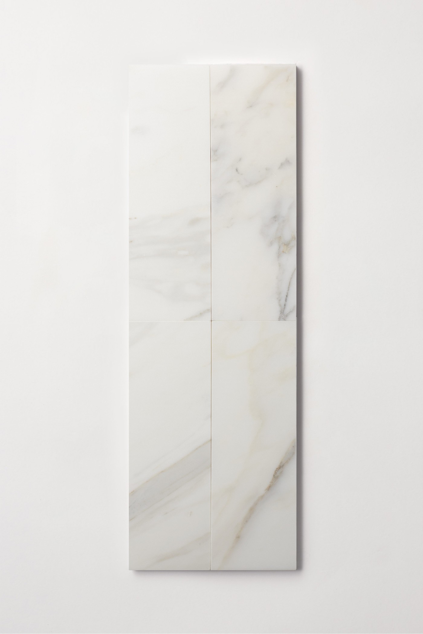 a white rectangular marble tile on a white surface.