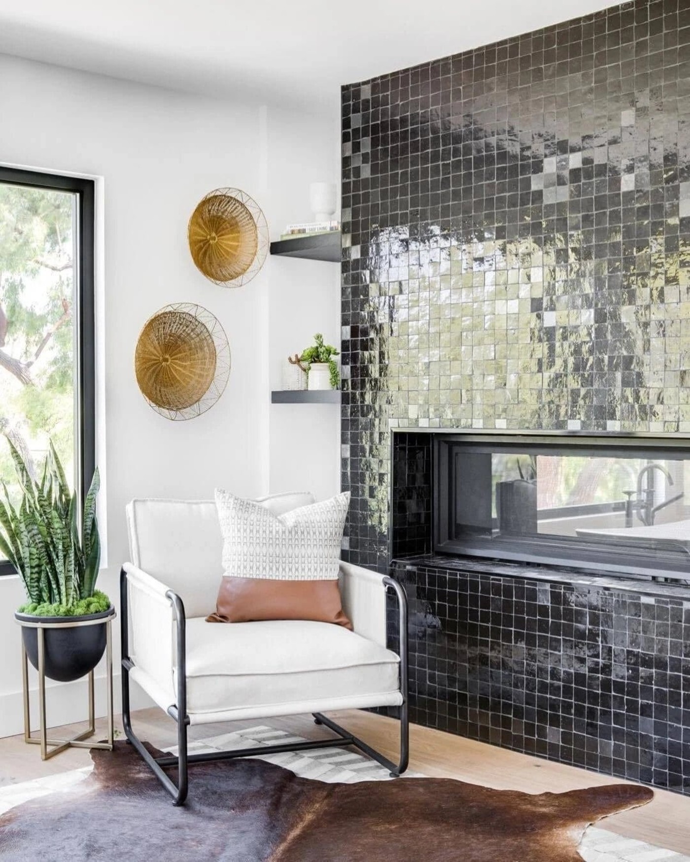 a living room with a black tiled wall.