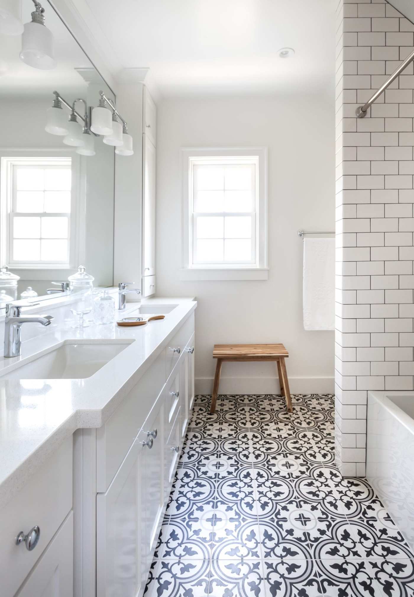 a bathroom with a black and white tile floor.