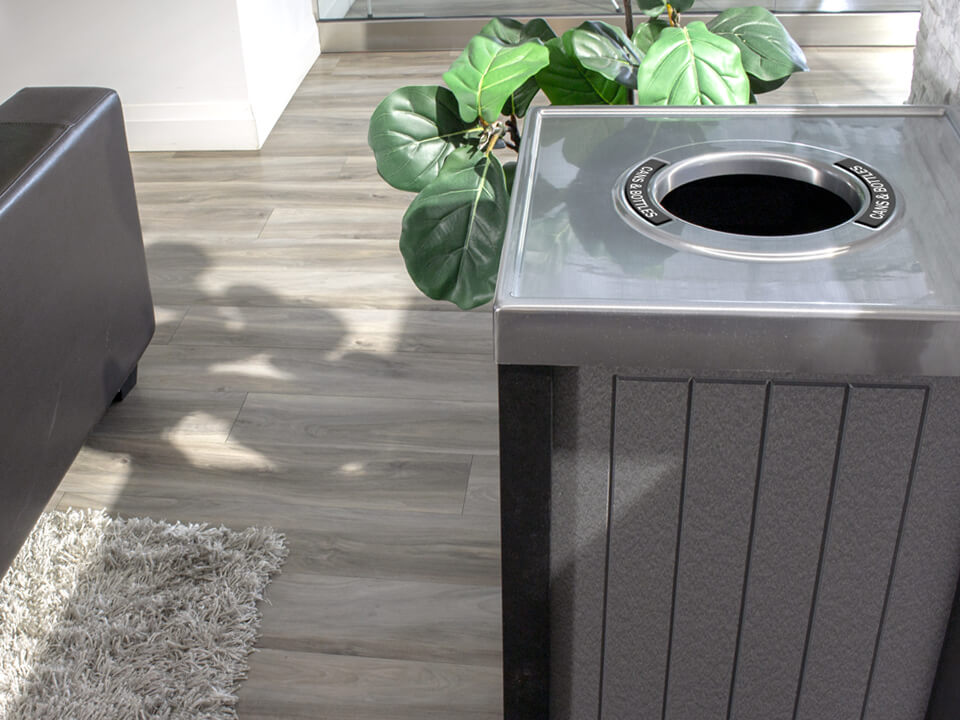 closeup of recycling bin with round opening for collecting cans and bottles in a modern office environment