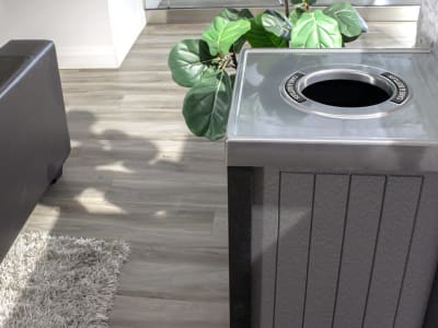 closeup of recycling bin with round opening for collecting cans and bottles in a modern office environment