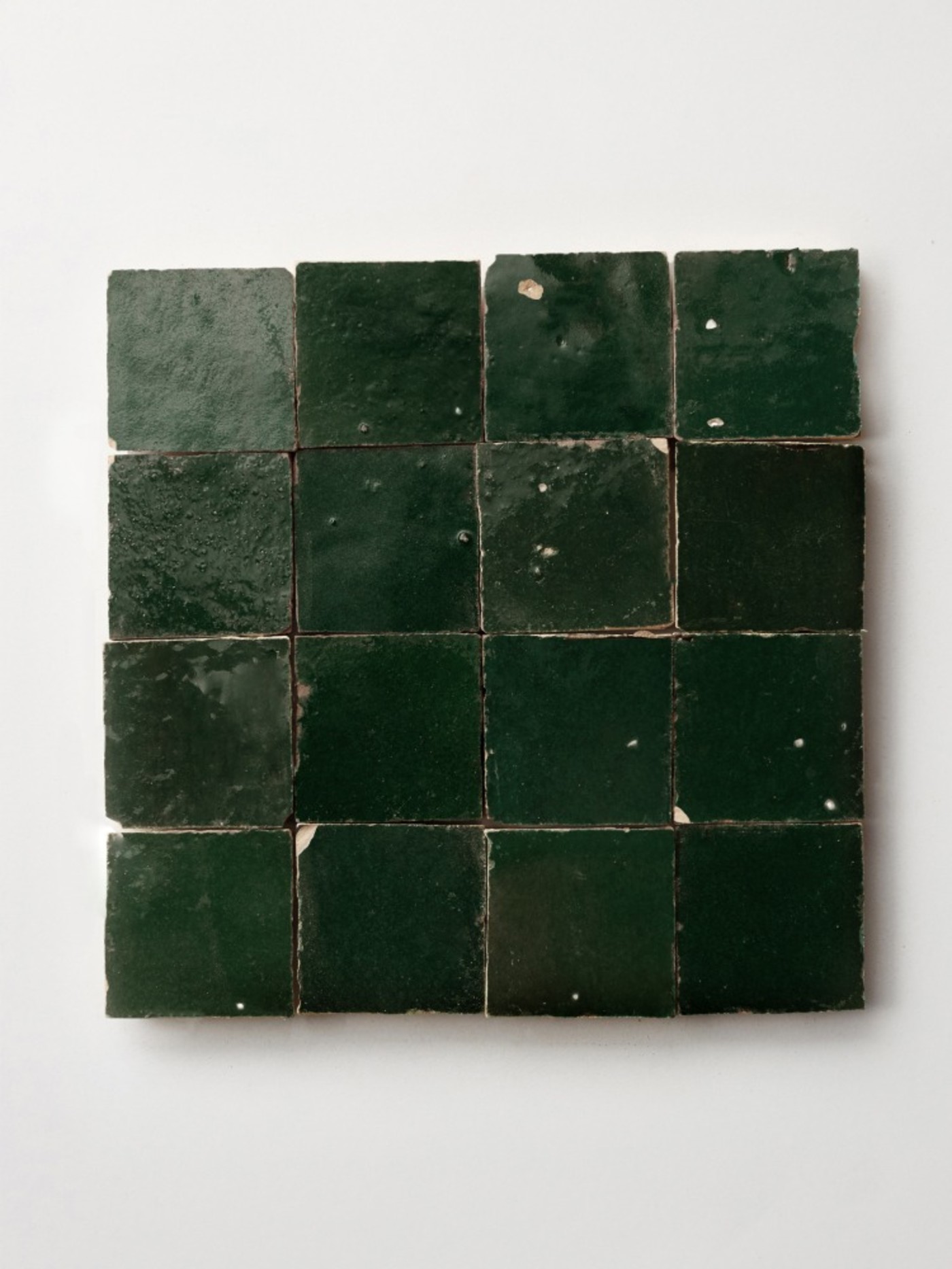 square green tiles on a white surface.