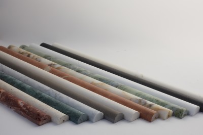 a row of marble rods on a white surface.