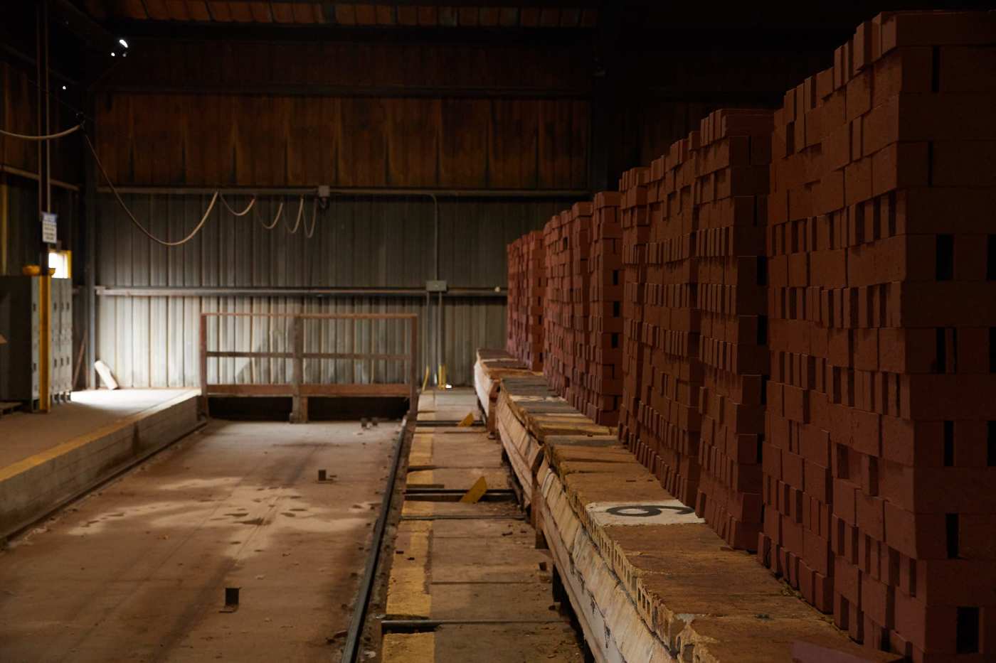 a row of brick pallets in a warehouse.