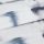 White linen curtain with horizontal folds and diffuse blue-gray brushstroke pattern; folded panel overlapping below, draped to show textured weave, photographed close-up under soft, diffuse lighting.