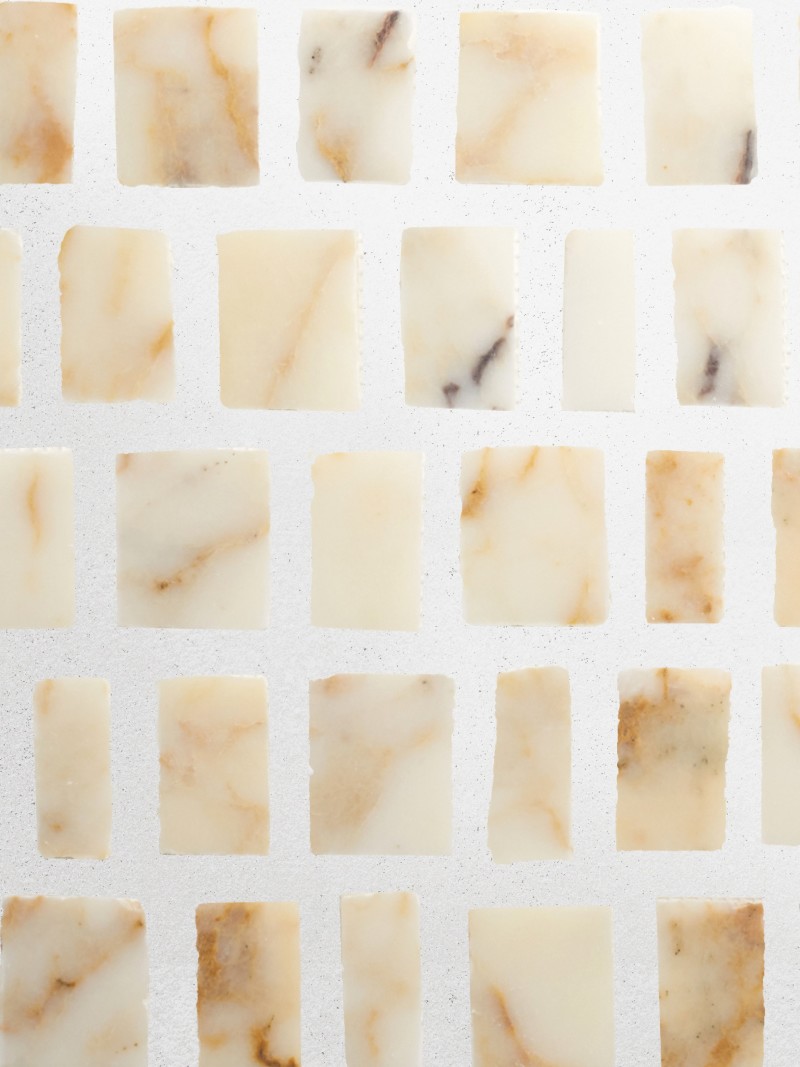 a white and brown marble tile on a white surface.