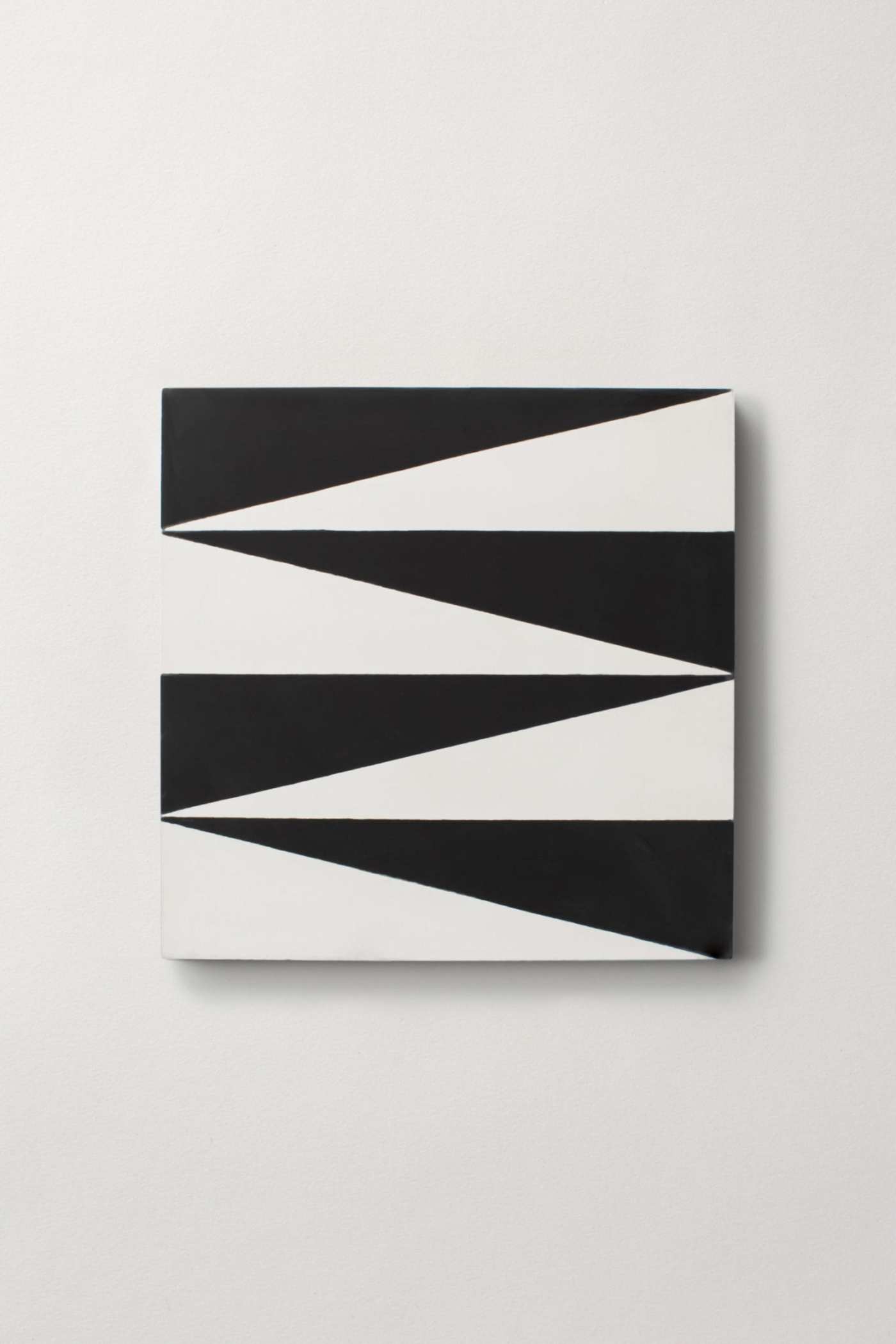 a black and white piece of tile on a white surface.