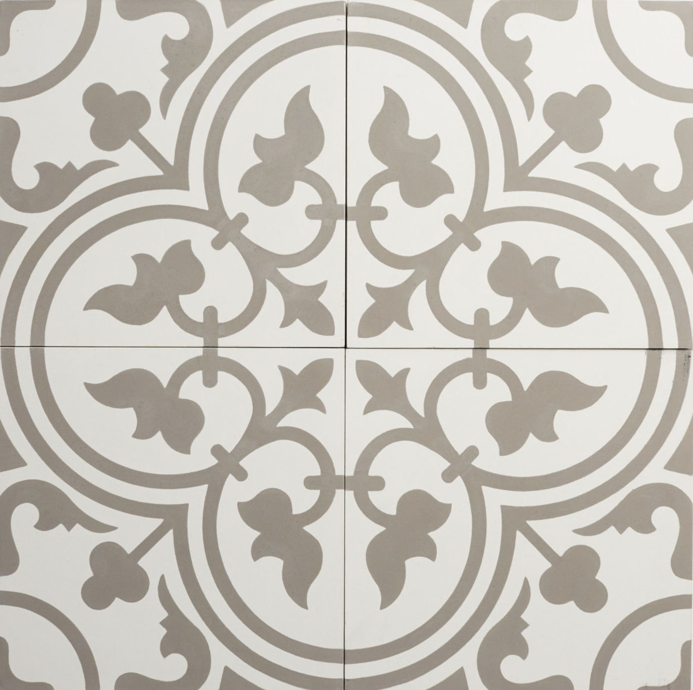 four square tiles forming an ornate design in grey and white.