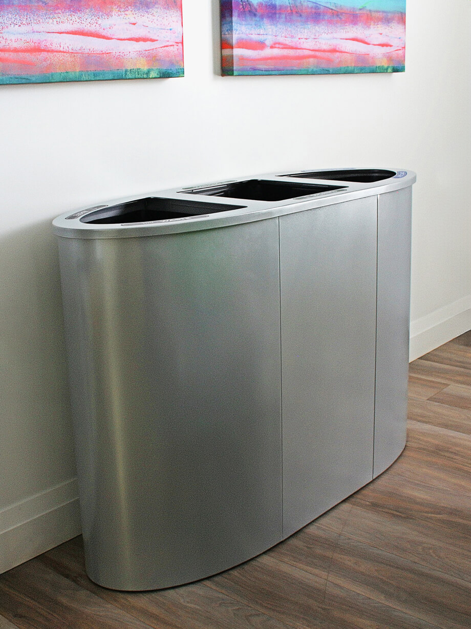 silver powder coated steel triple stream waste and recycling container with hinged lid in a modern office area