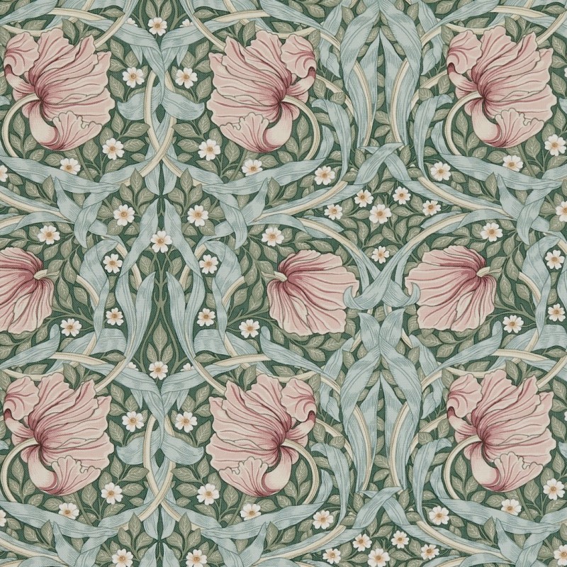 Wallpaper with large ruffled pink flowers, pale blue-green twisting leaves and tiny white blossoms â€” forming a symmetrical repeating pattern â€” on a muted green background suggesting vintage Arts-and-Crafts decor.