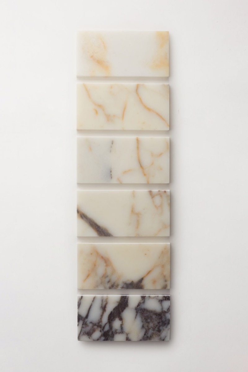 a row of marble tiles on a white surface.