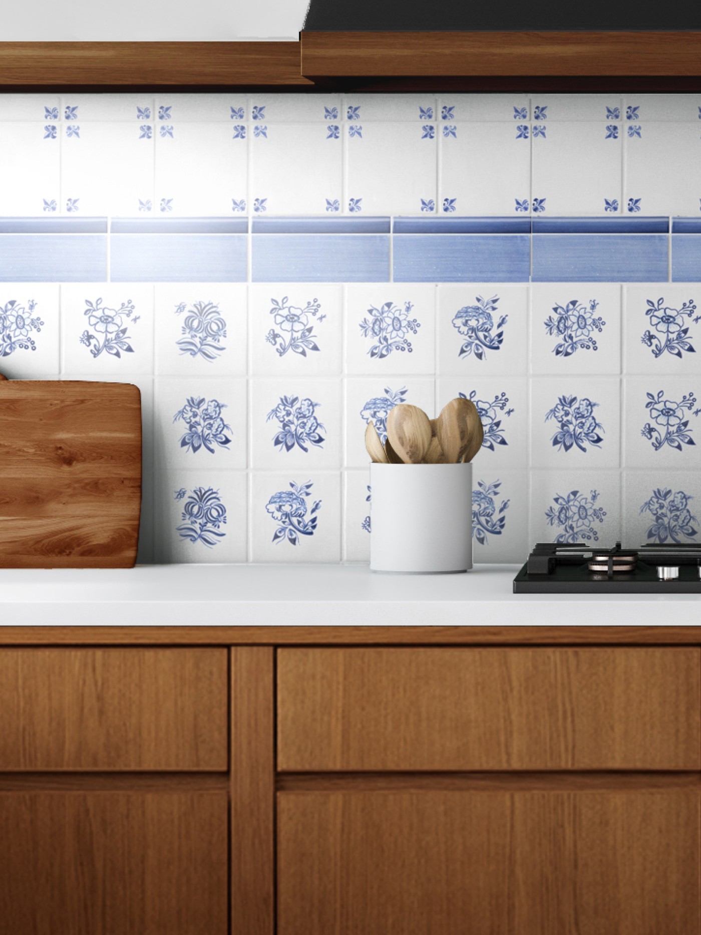 a blue and white tiled stove backsplash in a kitchen with wooden cabinets.