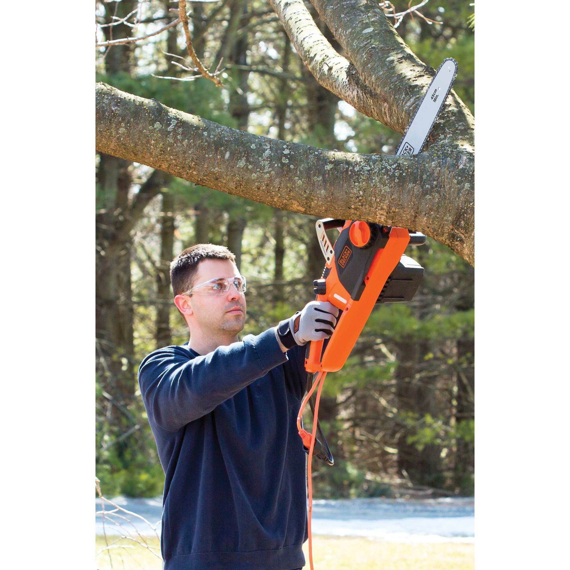 15 Amp 18 inch Chainsaw being used to cut thick tree branch.