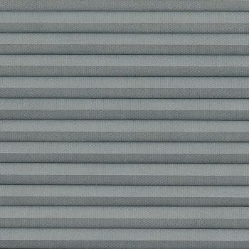 Gray pleated cellular window shade with horizontal accordion folds, fully lowered and closed, textured fabric and uniform spacing; close-up view filling frame under soft, diffuse lighting.