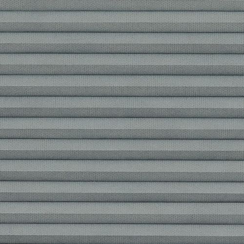 Gray pleated cellular window shade with horizontal accordion folds, fully lowered and closed, textured fabric and uniform spacing; close-up view filling frame under soft, diffuse lighting.