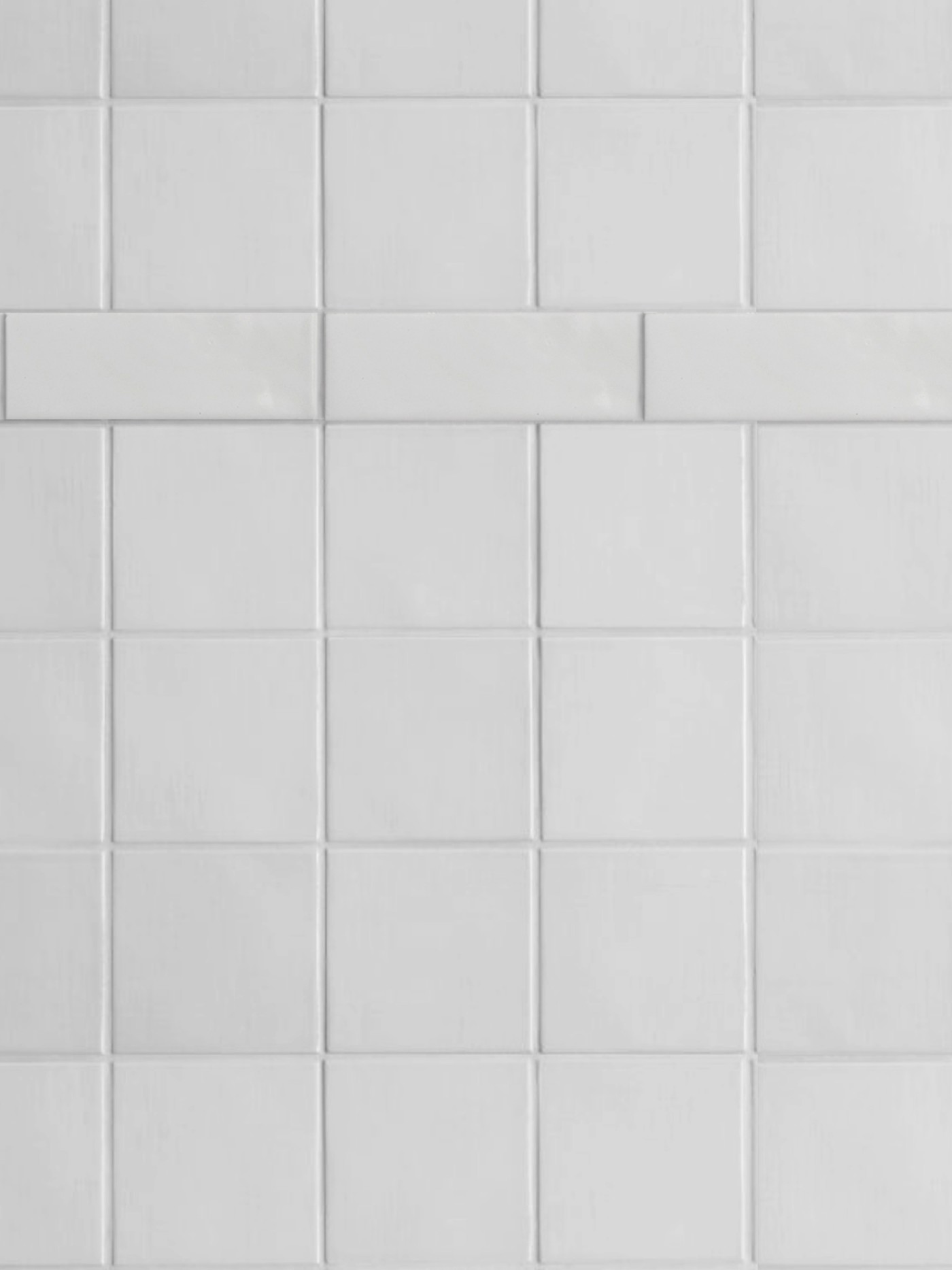 a close up of a white tiled wall.