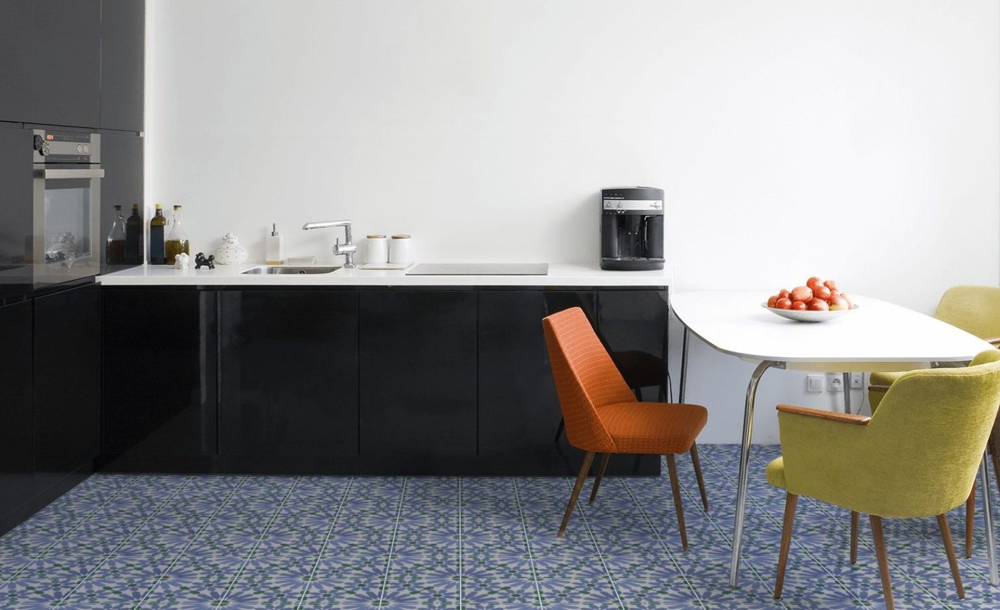 a kitchen with a blue tile floor and chairs.