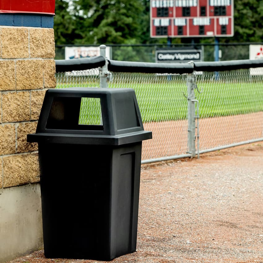 large outdoor trash bin made from durable black LDPE plastic outside at a baseball field