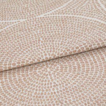 Beige and cream woven fabric with dense pebble-like dot pattern arranged in radiating rings; folded once across the frame, showing raised texture and subtle sheen in neutral studio lighting.