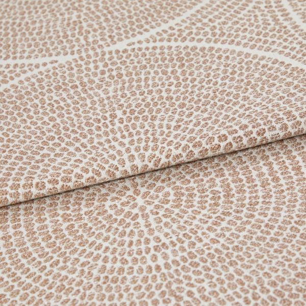 Beige and cream woven fabric with dense pebble-like dot pattern arranged in radiating rings; folded once across the frame, showing raised texture and subtle sheen in neutral studio lighting.