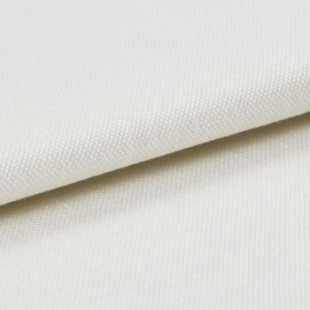 Cream-coloured textured canvas fabric, folded with one layer overlapping another, showing tight plain weave; photographed under soft studio lighting on a neutral background, close-up detail of surface.