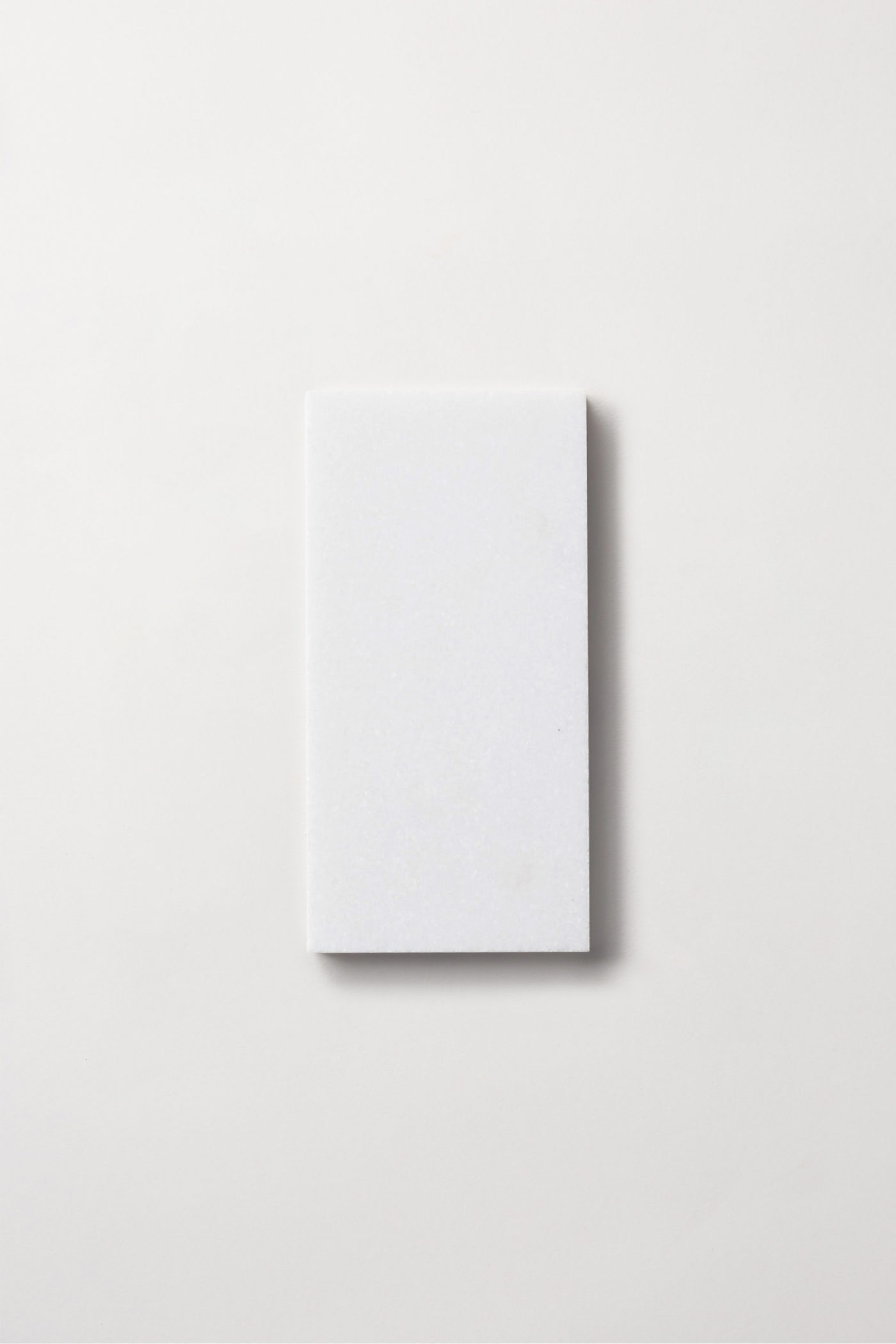 a white rectangle tile on a white background.