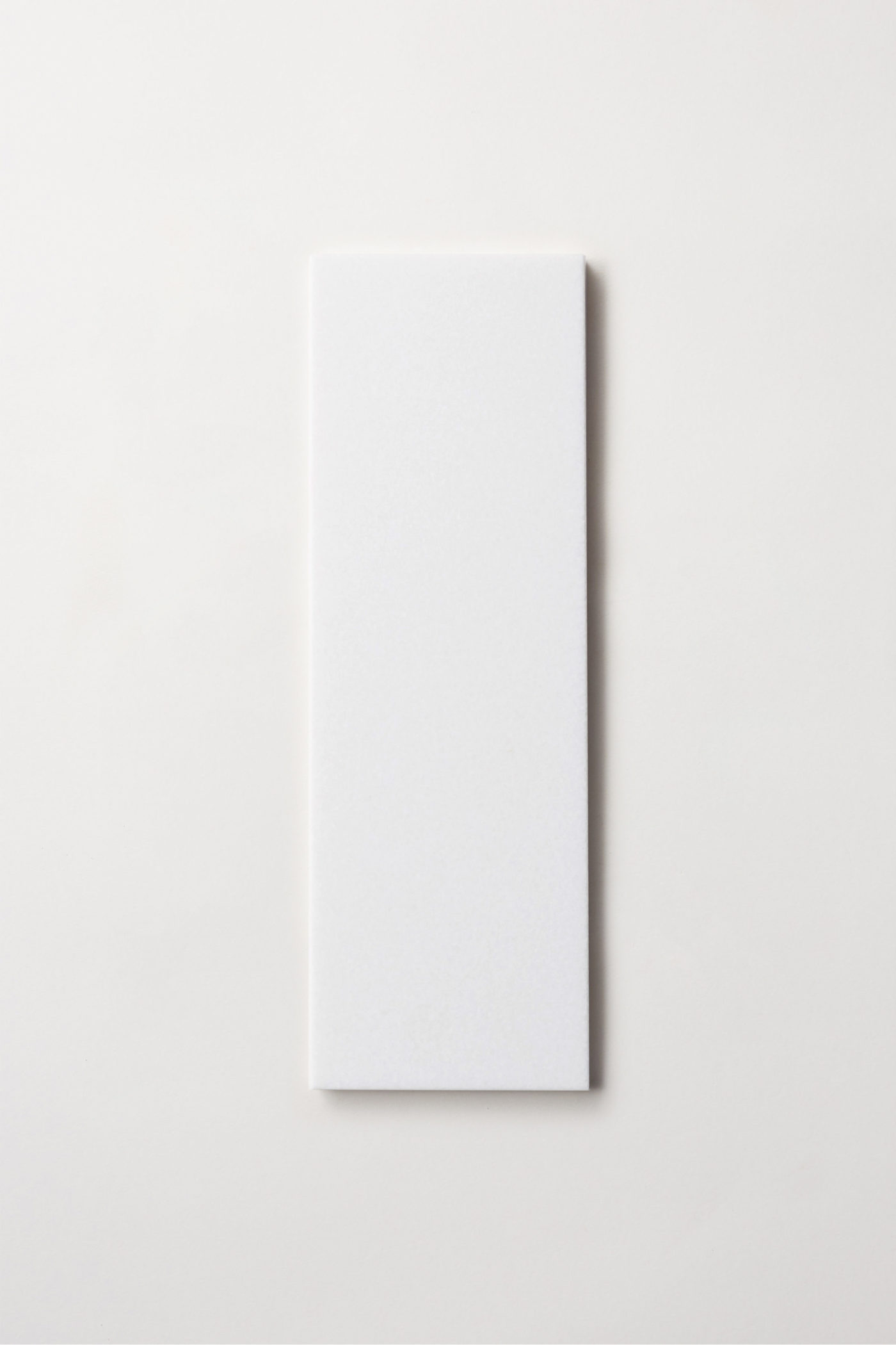 a white rectangle tile on a white background.