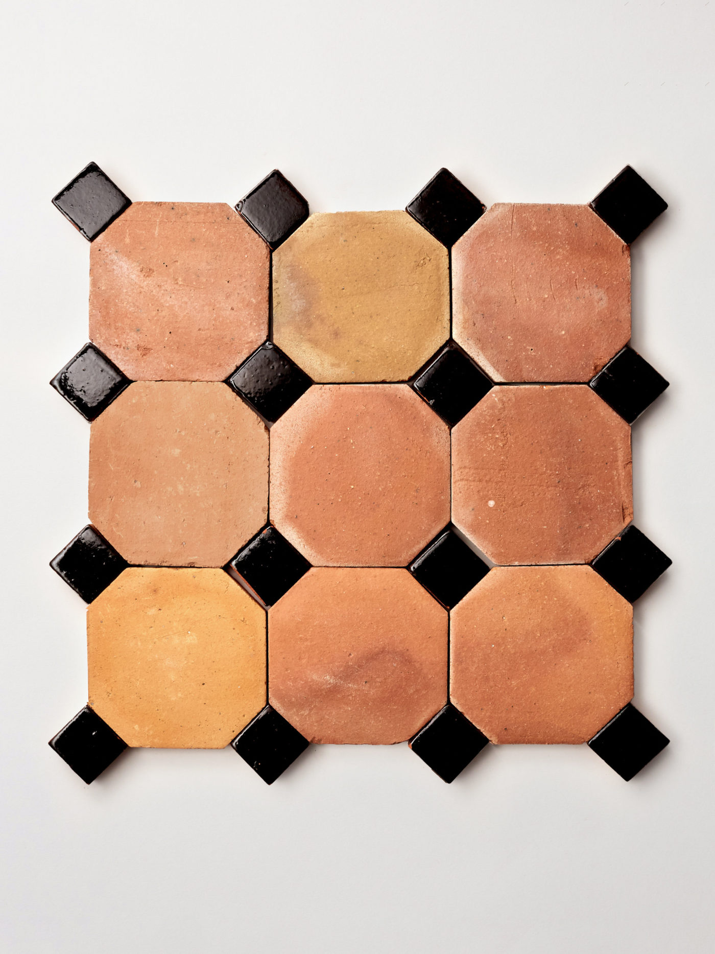 terracotta tiles arranged in a pattern on a white surface.