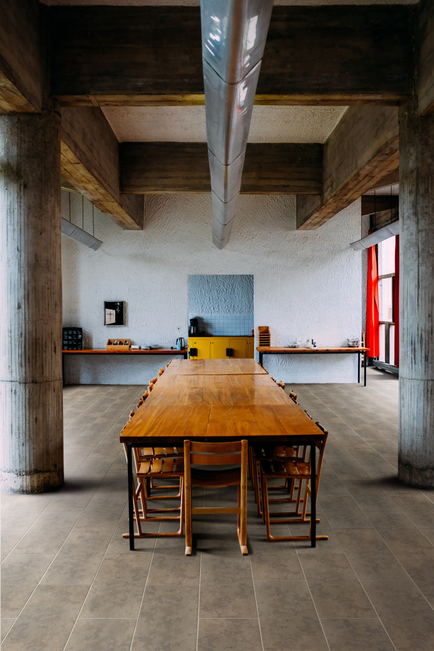 a large room with a long wooden table and chairs.