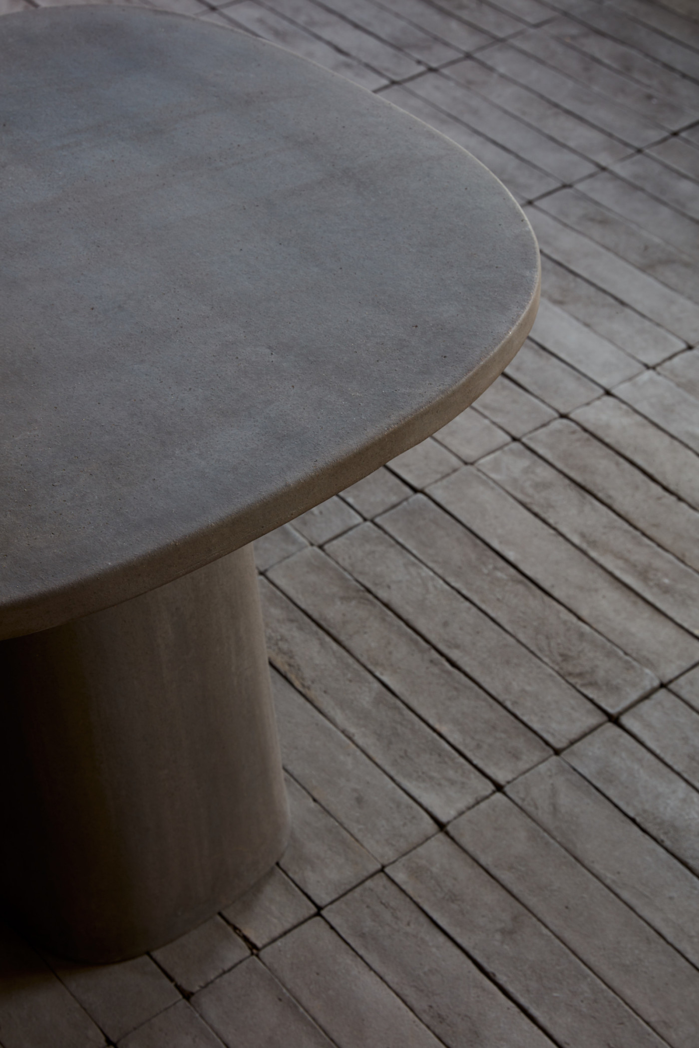 a black wooden table on a dark tiled floor.