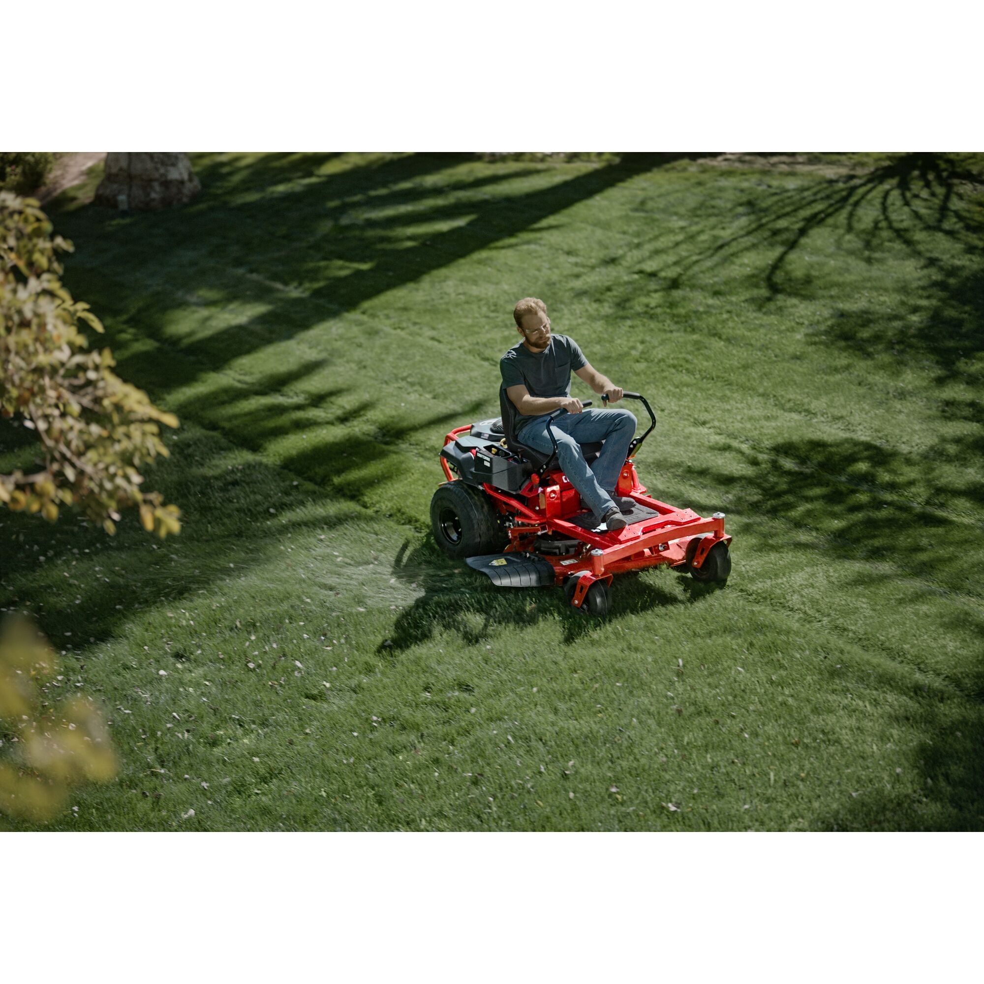 Top view of 22 h p 46 inch zero turn riding mower being used by a person to mow the lawn.