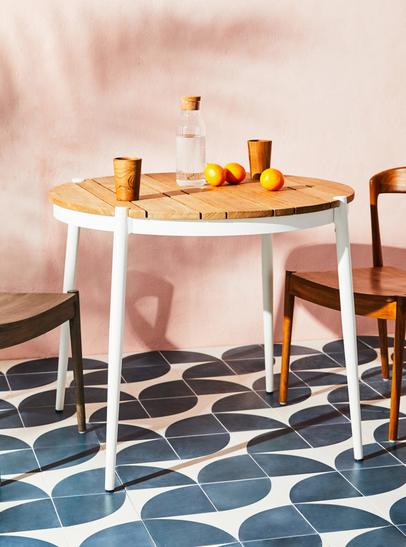 two chairs and a table on a tiled floor.