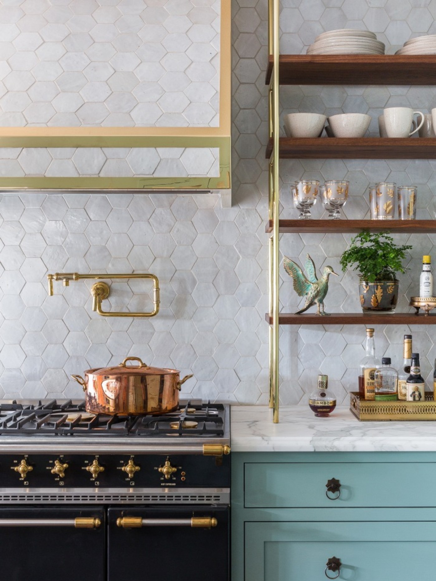 a kitchen with white hex tile backsplash.