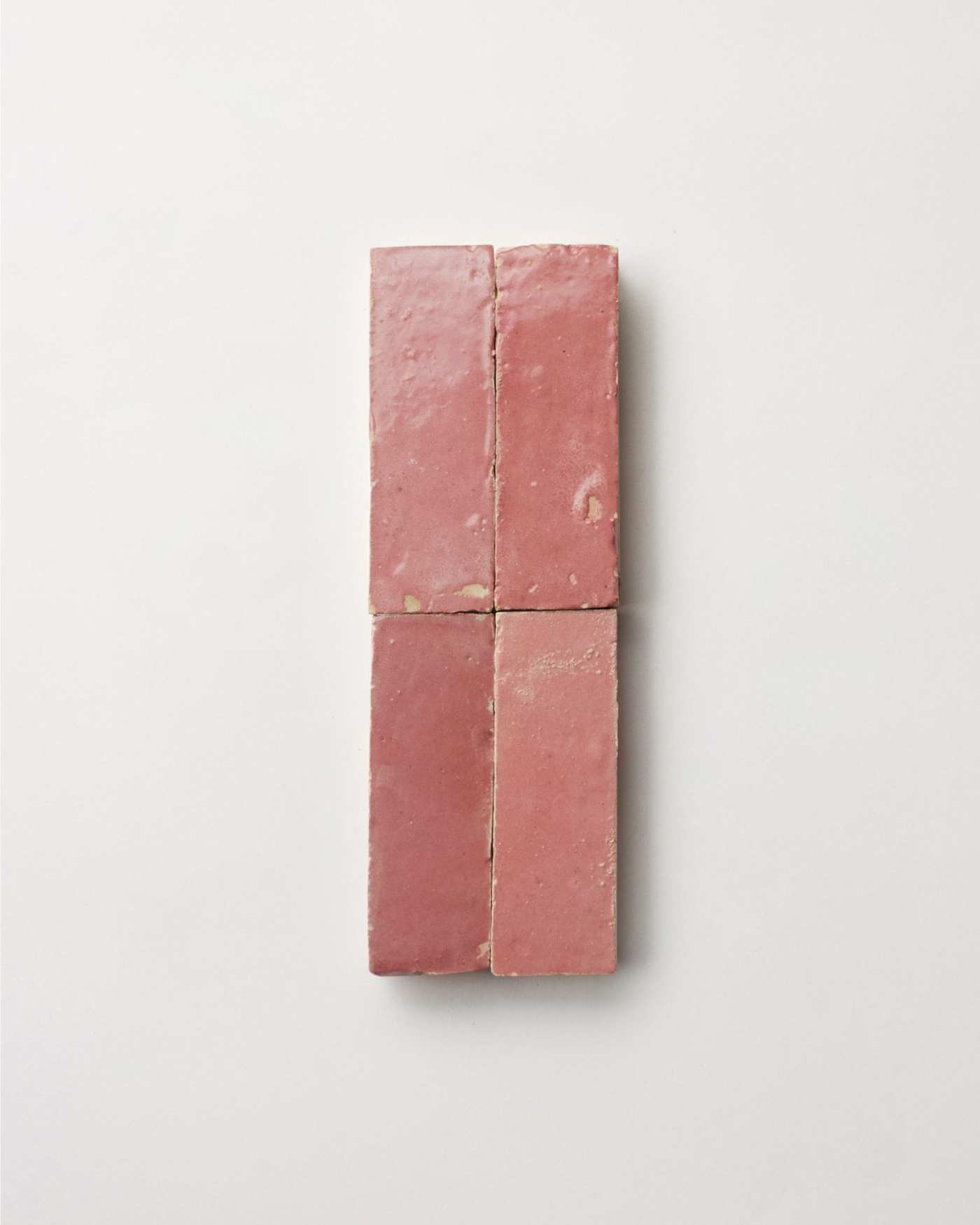 4 pink tiles arranged on a white background.