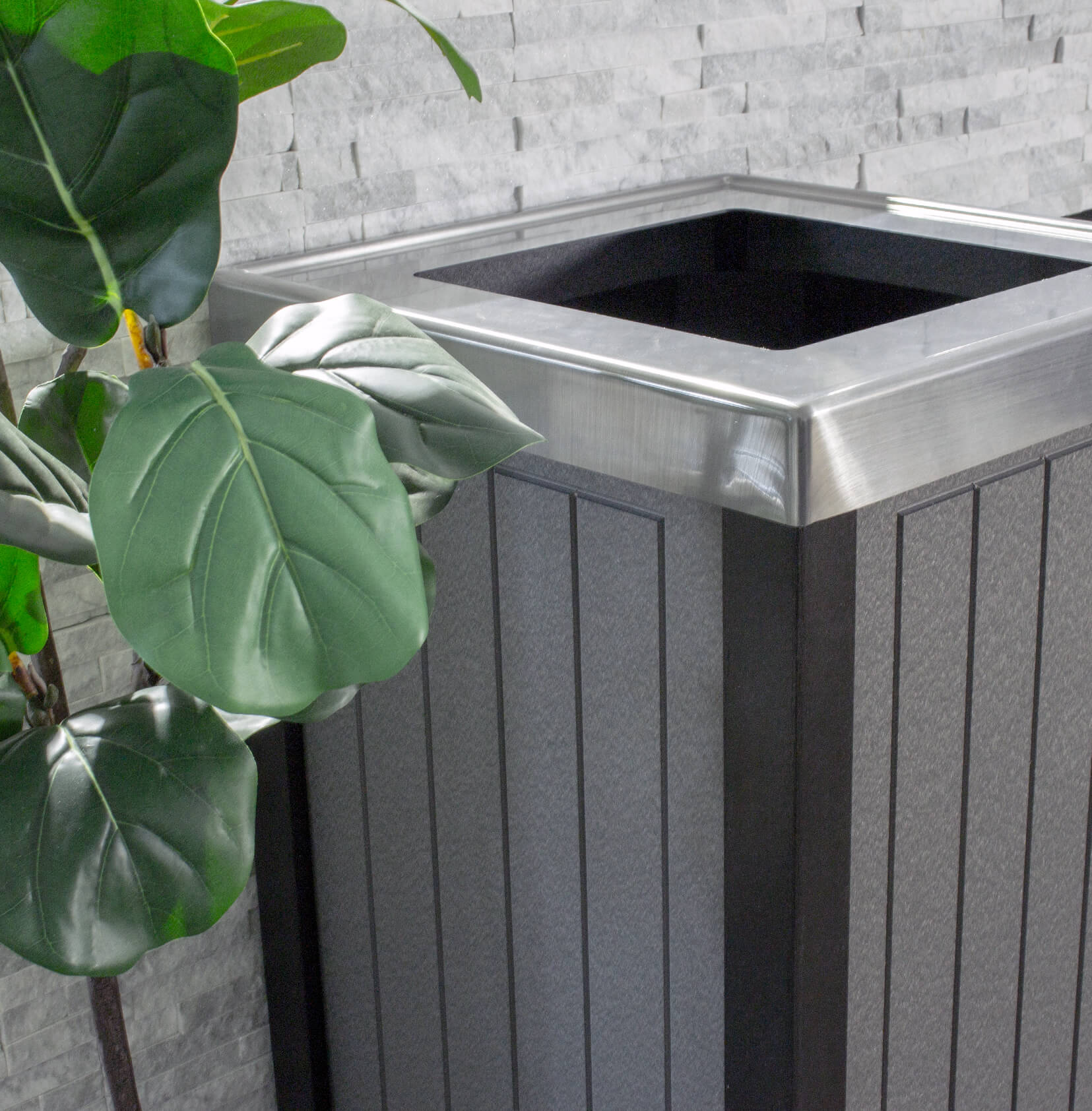 grey and black trash container with a stainless steel looking lid