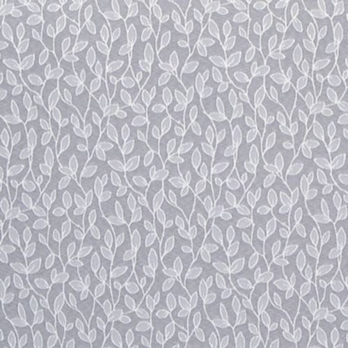 Sheer, white-embroidered curtain hung flat, its repeating vine-and-leaf motif running vertically; filtering soft light against a muted gray background, suggesting an interior window or decorative wall covering.