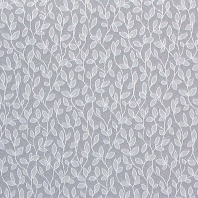 Sheer, white-embroidered curtain hung flat, its repeating vine-and-leaf motif running vertically; filtering soft light against a muted gray background, suggesting an interior window or decorative wall covering.