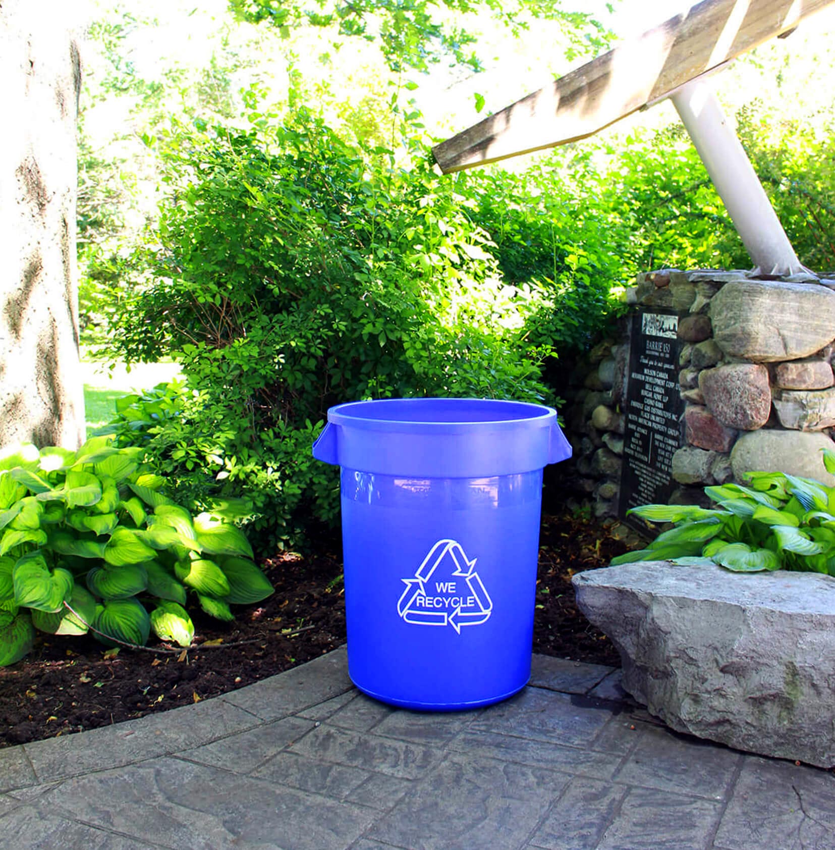 large blue plastic bin for collecting recyclables at a city park