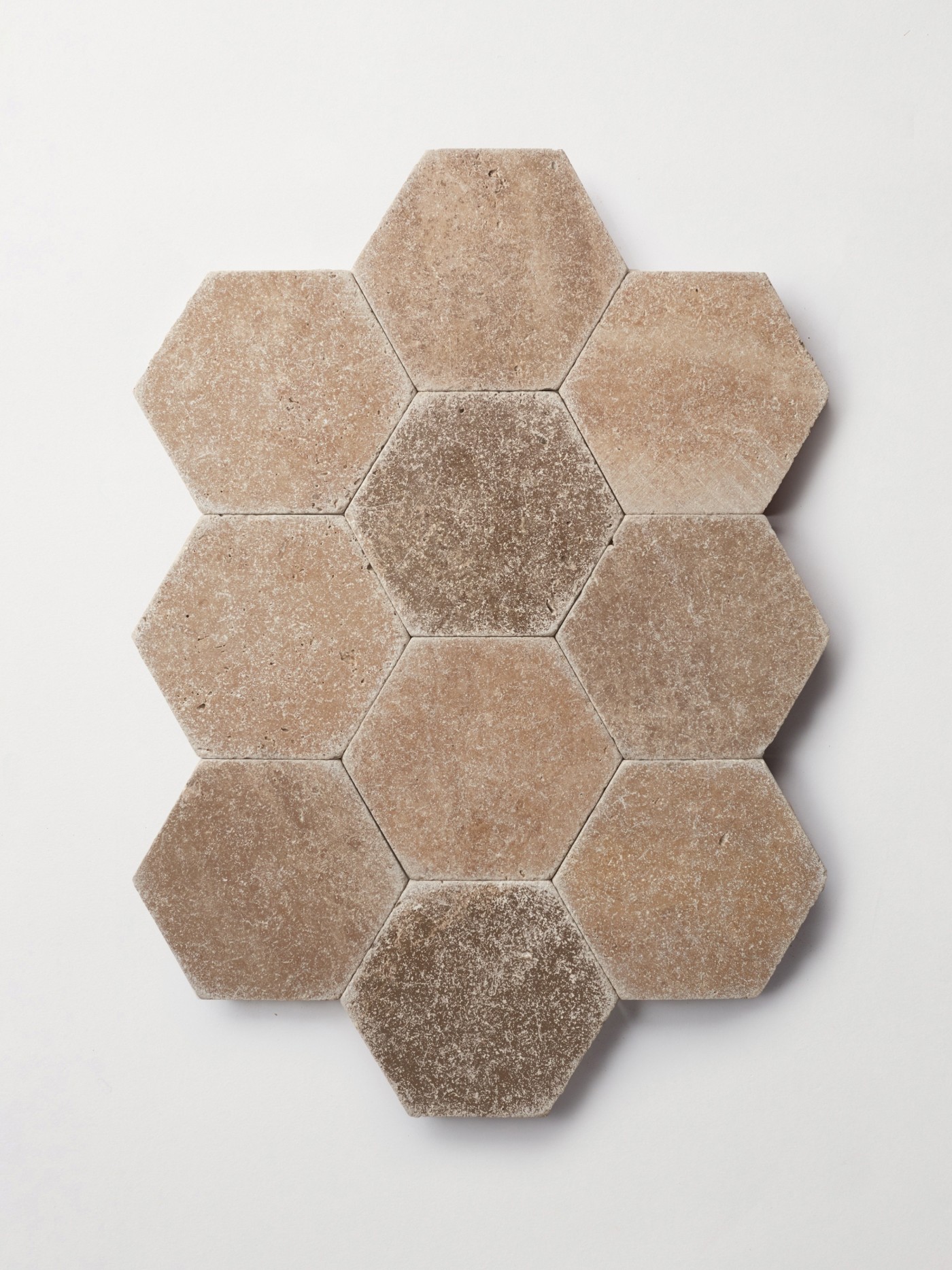 hexagonal tiles with brown and beige colors on a white surface.