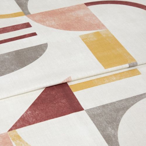 Folded geometric-print curtain panel, showing a visible hem and muted mustard, terracotta and gray semi-circles and rectangles; lying flat in a close-up studio shot with soft, even lighting.