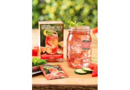 Mason jar filled with Watermelon Cucumber Mint Cold Water Infusion with tea box and foil