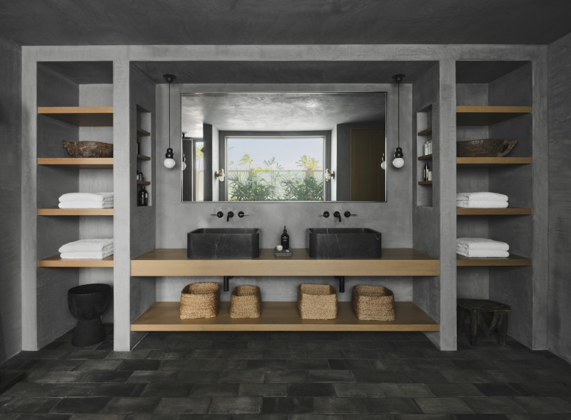an image of a bathroom with two sinks and several shelves.