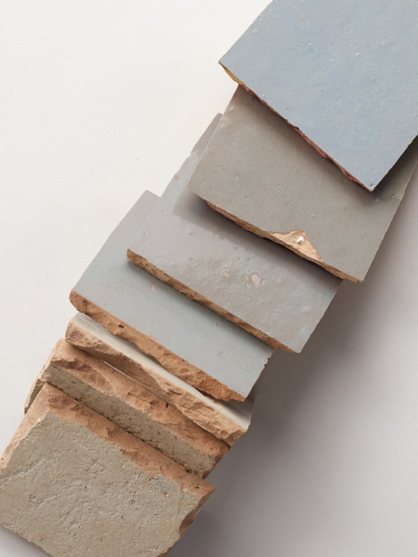 a stack of blue tiles on a white surface.