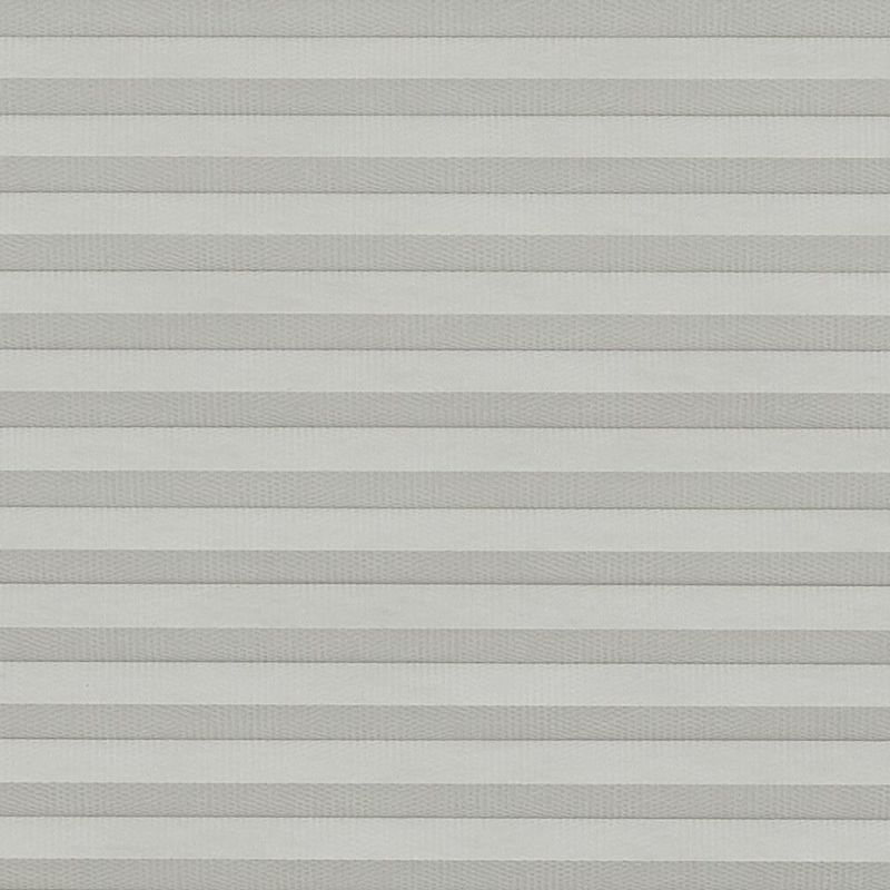 Light-gray pleated cellular blinds, lowered and fully closed, diffusing soft daylight; covering a window in a neutral, evenly lit interior with no outside view visible.
