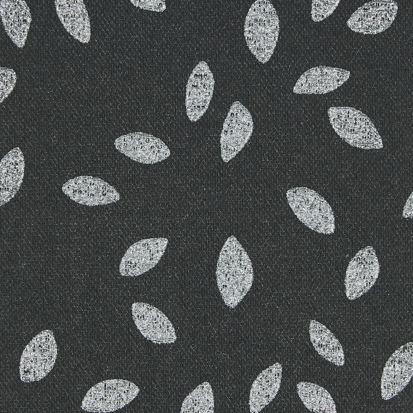 Dark charcoal woven fabric patterned with scattered white, textured leaf-shaped ovals; motifs roughly evenly spaced, creating a repeating decorative design; close-up, flat diffuse lighting and no visible surroundings.