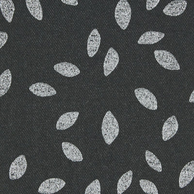 Dark charcoal woven fabric patterned with scattered white, textured leaf-shaped ovals; motifs roughly evenly spaced, creating a repeating decorative design; close-up, flat diffuse lighting and no visible surroundings.