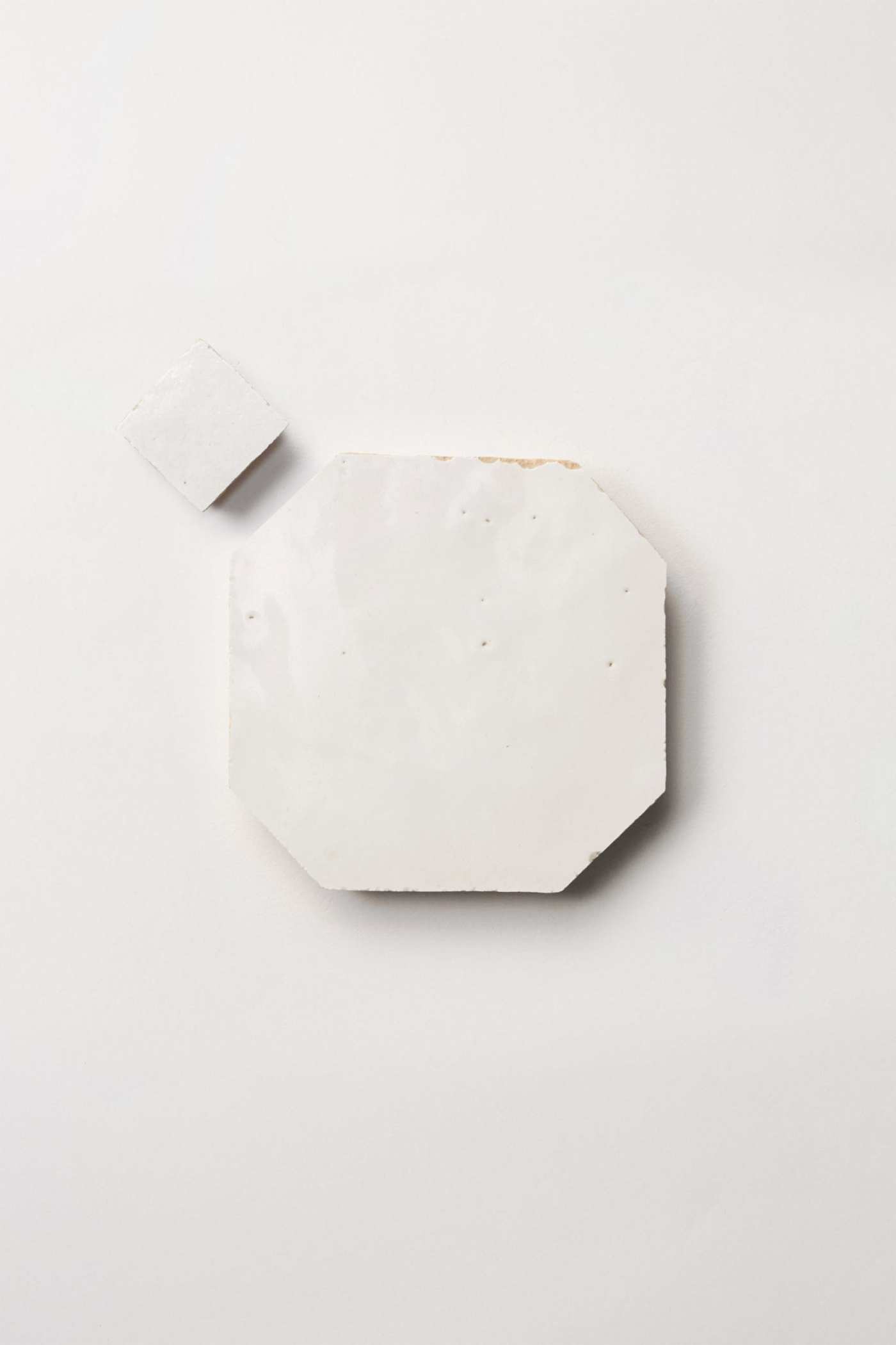 a white plate on a white surface.