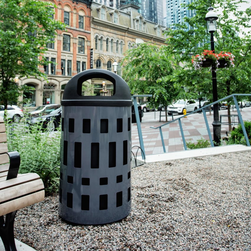 steel powder coated body with durable LDPE plastic liner and domed canopy lid in an outdoor municipal park area