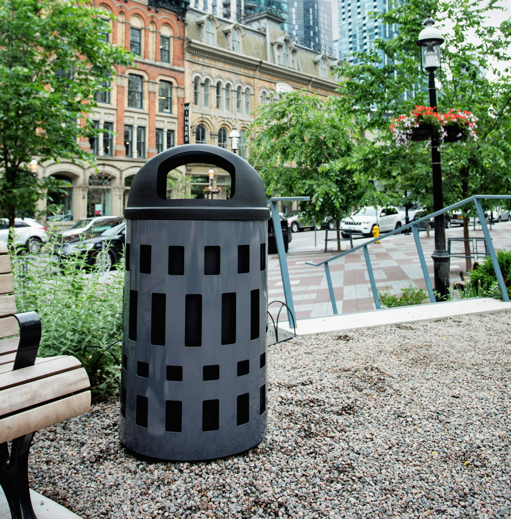 steel powder coated body with durable LDPE plastic liner and domed canopy lid in an outdoor municipal park area